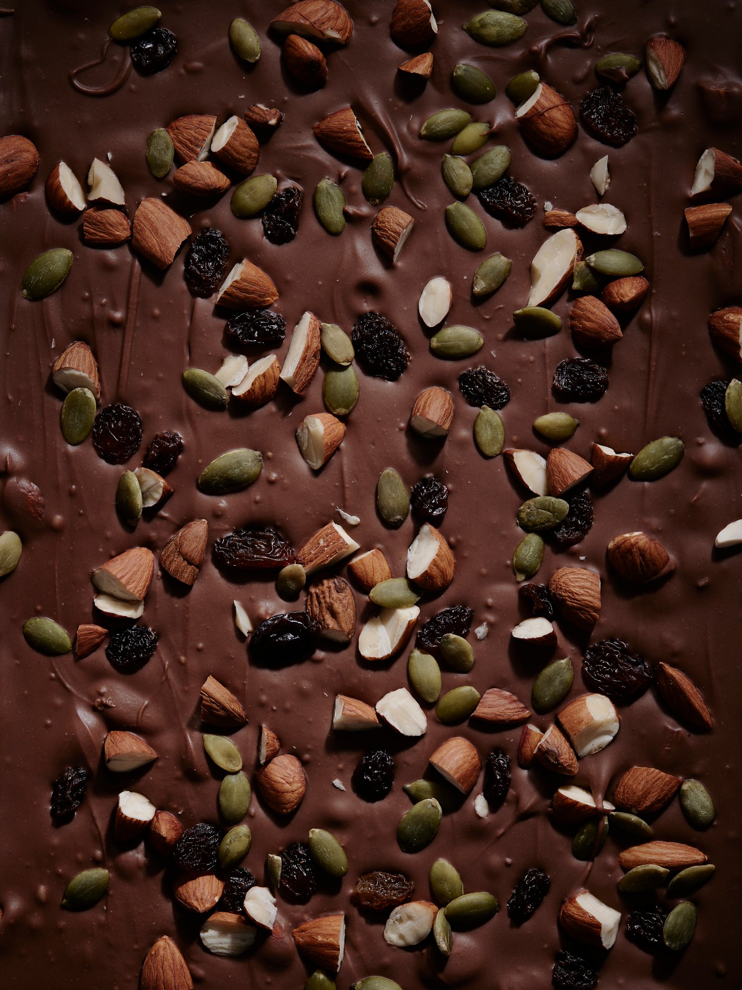 Chocolate bark studded with almonds, pumpkin seeds and dried berries, Chocolate by Hannah Caldwell