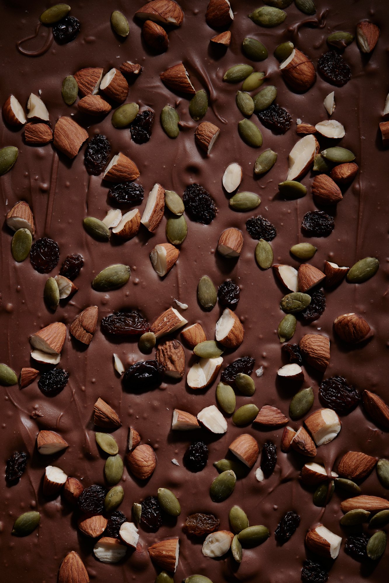 Chocolate bark studded with almonds, pumpkin seeds and dried berries, Chocolate by Hannah Caldwell