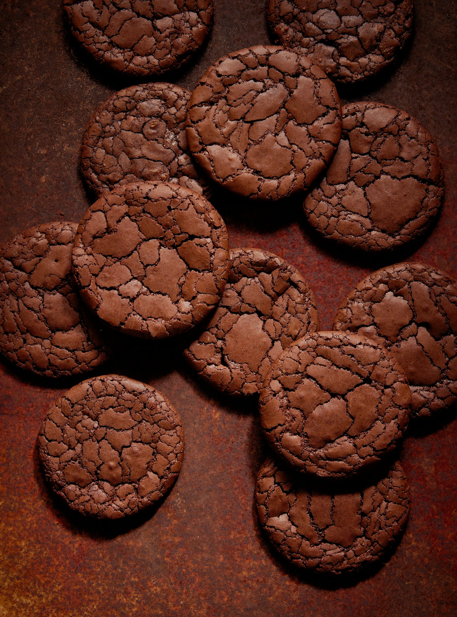 Cracked chocolate cookies cooling on a rusted tray, Chocolate by Hannah Caldwell