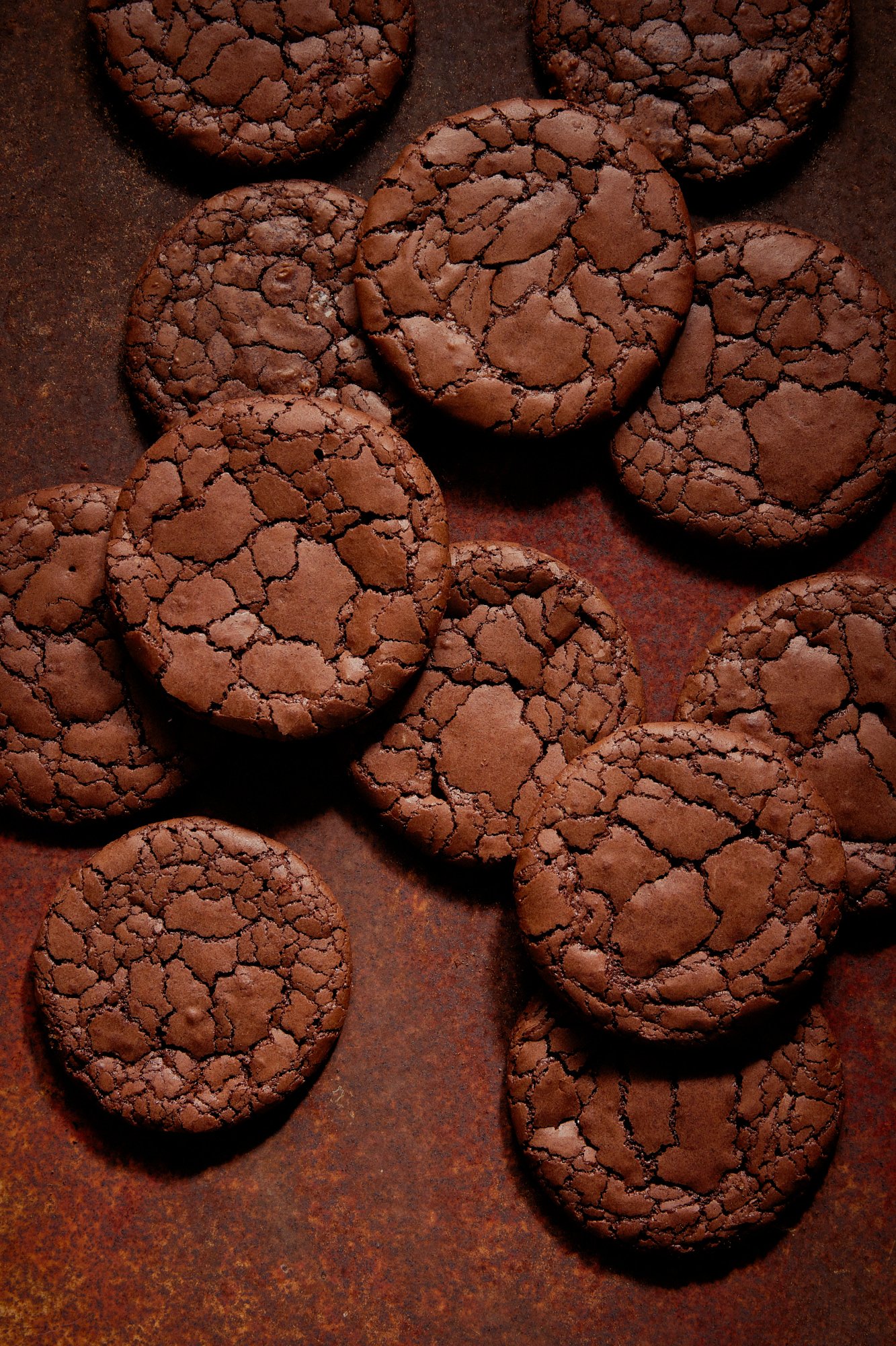 Cracked chocolate cookies cooling on a rusted tray, Chocolate by Hannah Caldwell