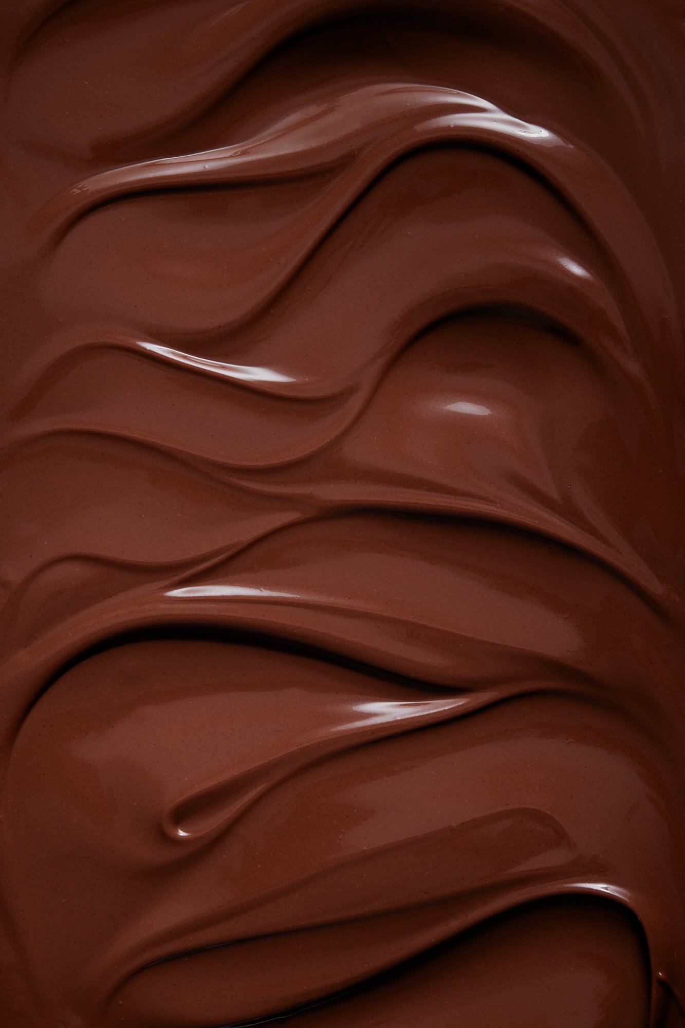 Melted chocolate spread into soft glossy waves, Chocolate by Hannah Caldwell