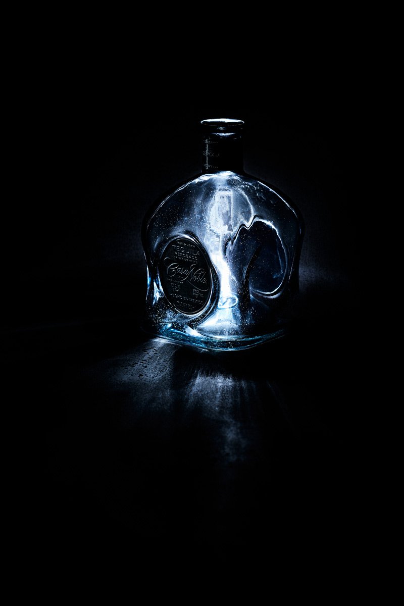 A moulded decanter holding cold light inside its shaped walls, Glass by Hannah Caldwell